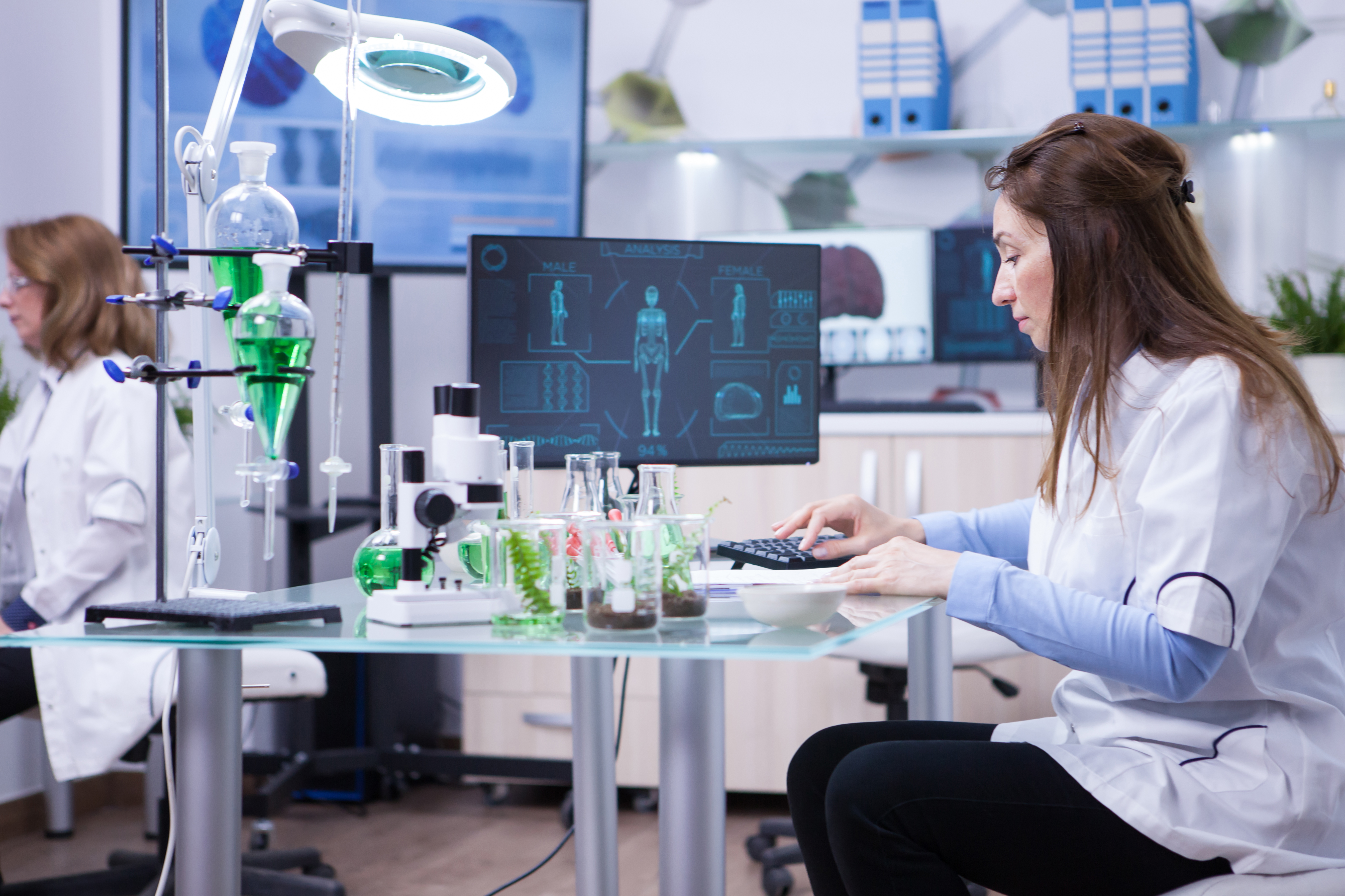 female-scientist-typing-her-computer-data-from-last-scientific-tests-chemistry-lab